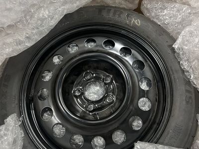 Maxxis Spare Tire on Black Steel Wheel with Scissor Jack