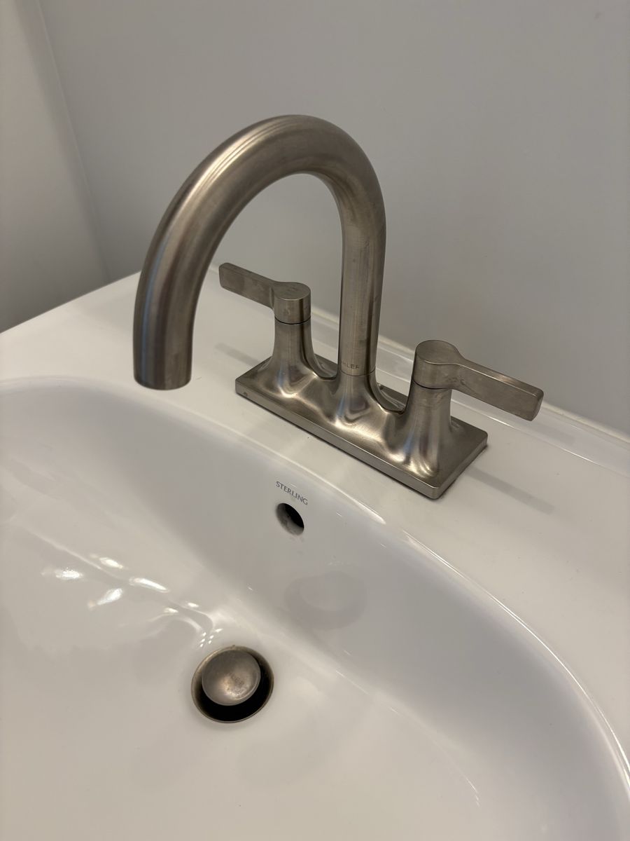 New Pedestal sink with Brushed Nickel Kohler Faucet, Towel Bar and Toilet Paper Holder.