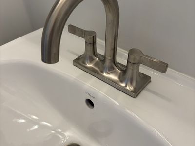 New Pedestal sink with Brushed Nickel Kohler Faucet, Towel Bar and Toilet Paper Holder.