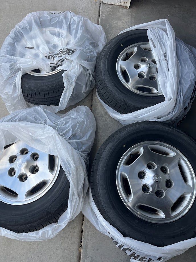 Four - 15 Inch Wheels and 215/70R15 Tires