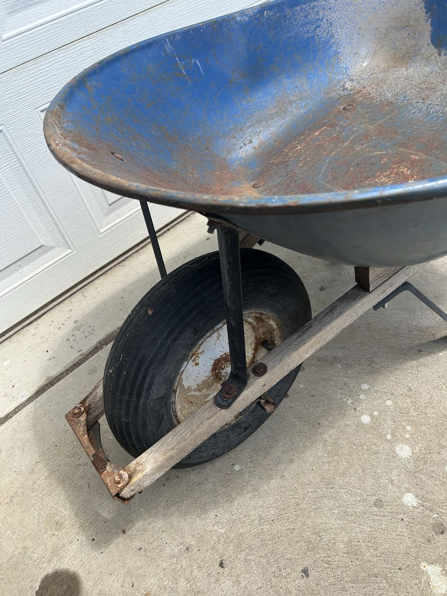 Blue Steel Wheelbarrow with Wooden Handles and Pneumatic Tire