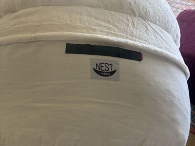 Large white been bag chair. Also folds out into a bed