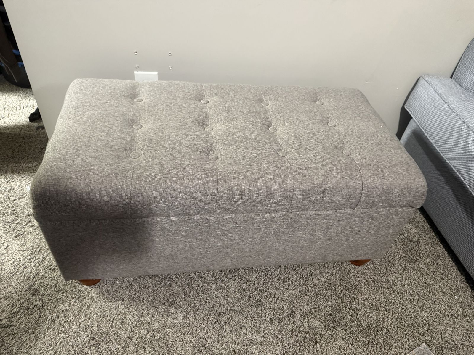 Grey/sandy bench with storage