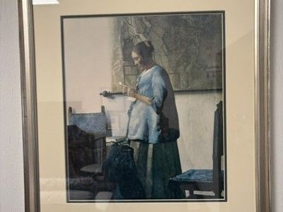 Framed reproduction of Johannes Vermeer's painting, "Woman Reading a Letter"