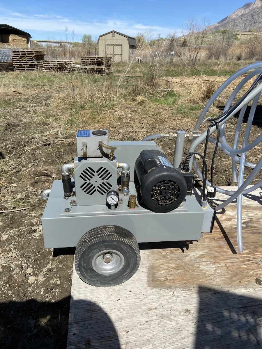 Portable Milking machine with buckets.