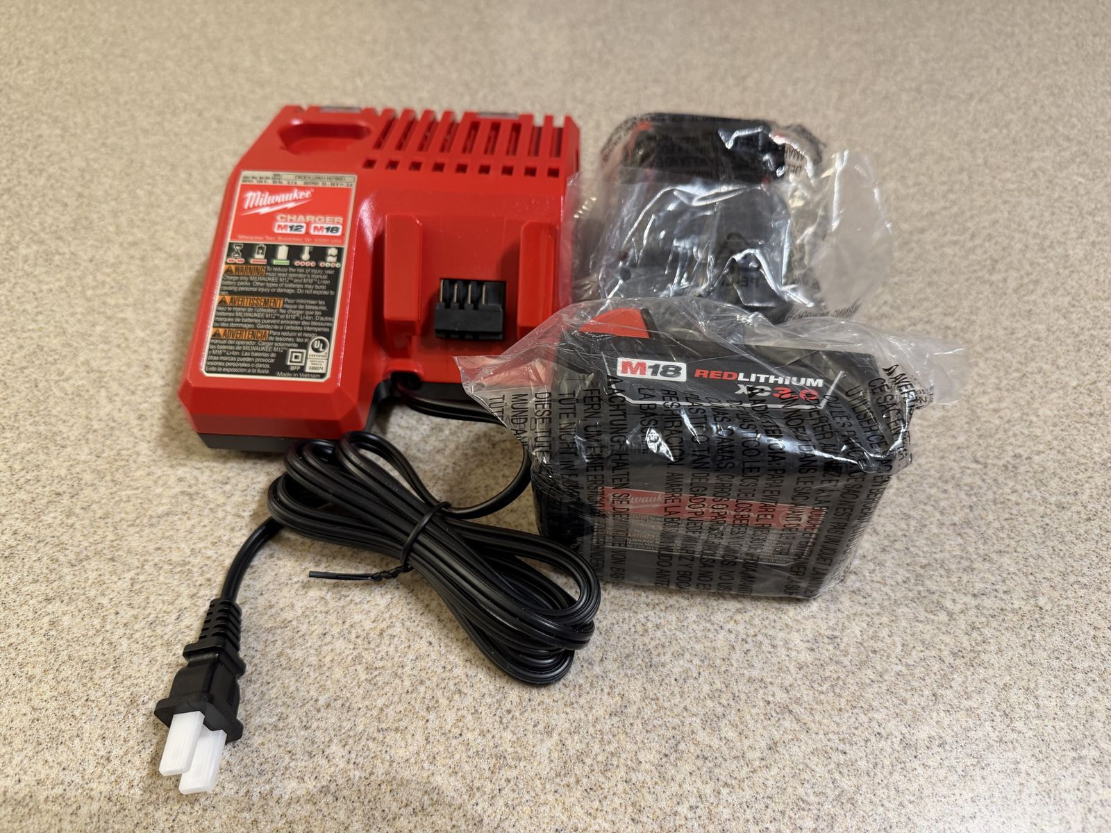 Brand new Milwaukee M18 Charger and Two 3AH batteries