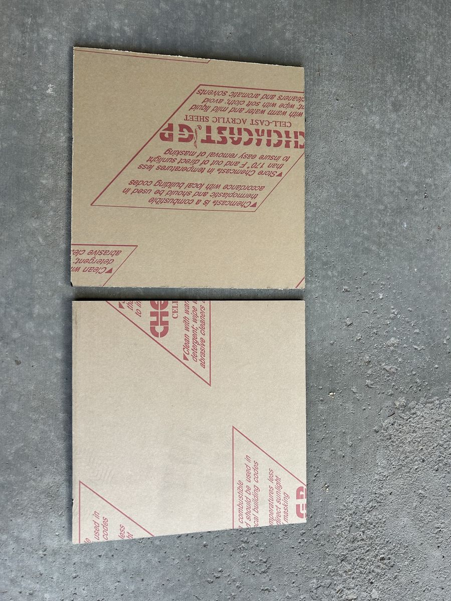 Two 12”x12” pieces of black acrylic board