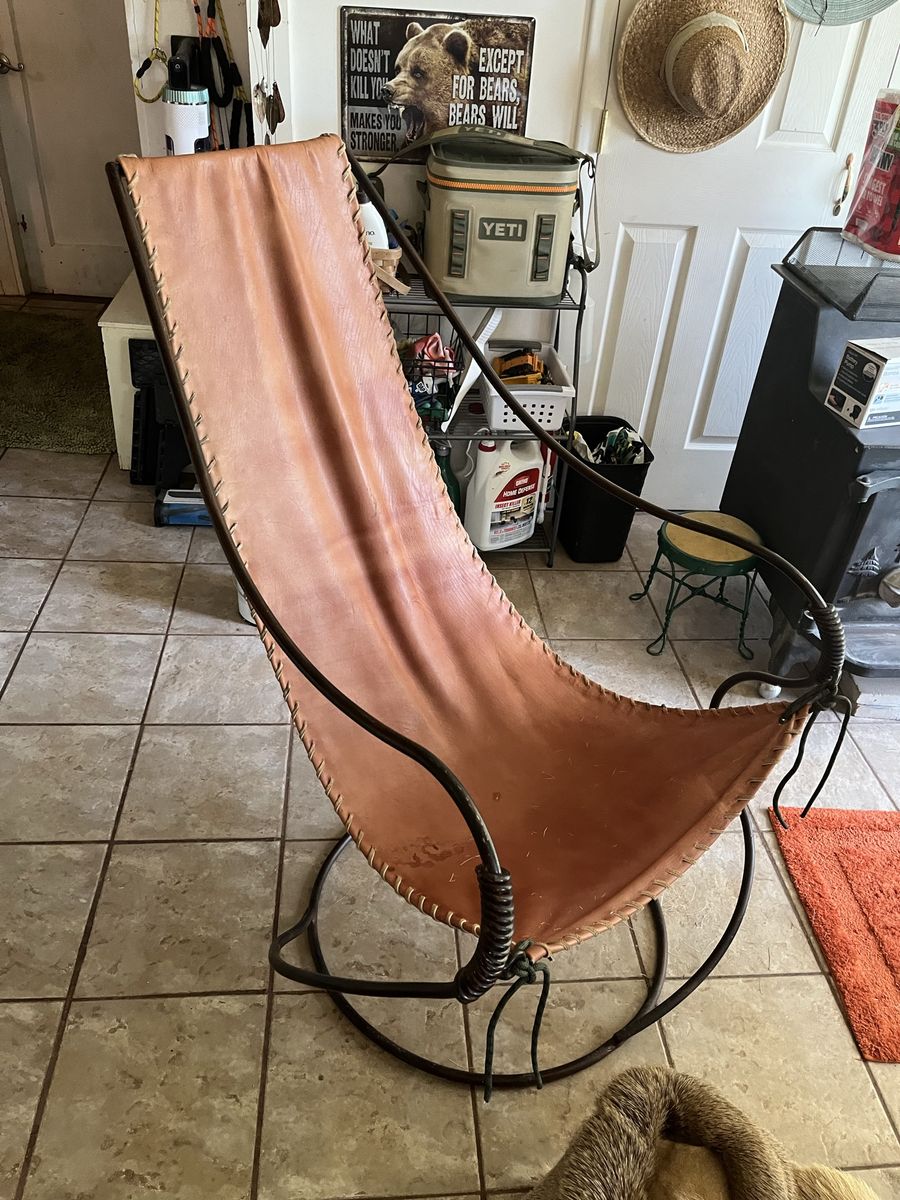 Leather sling and coil rod iron chair,This is a very interesting and a conversation piece,