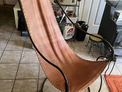 Leather sling and coil rod iron chair,This is a very interesting and a conversation piece,