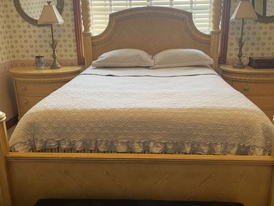 Elegant queen Size Wooden Poster Bed Frame with Intricate Carved Columns and Headboard, two night stand and wardrobe.
