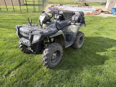 2009 Polaris Sportsman 800, gun rack and game bags.