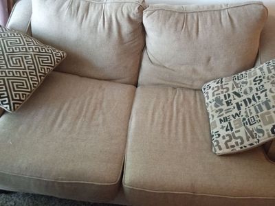 Neutral Tan Upholstered Two-Seater Sofa with Armrests