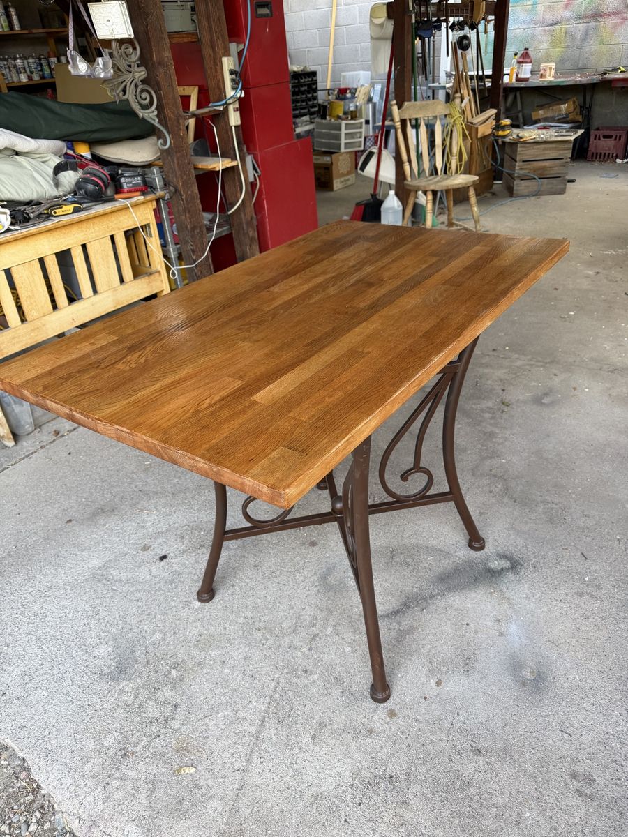 Wooden Table with Ornate Metal Base