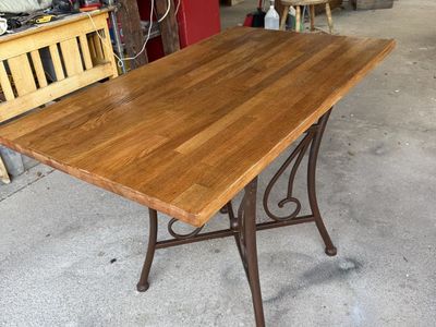 Wooden Table with Ornate Metal Base