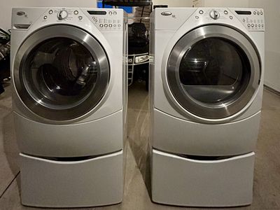 Whirlpool Duet Steam Front Load Washer and Dryer Set with Pedestals.