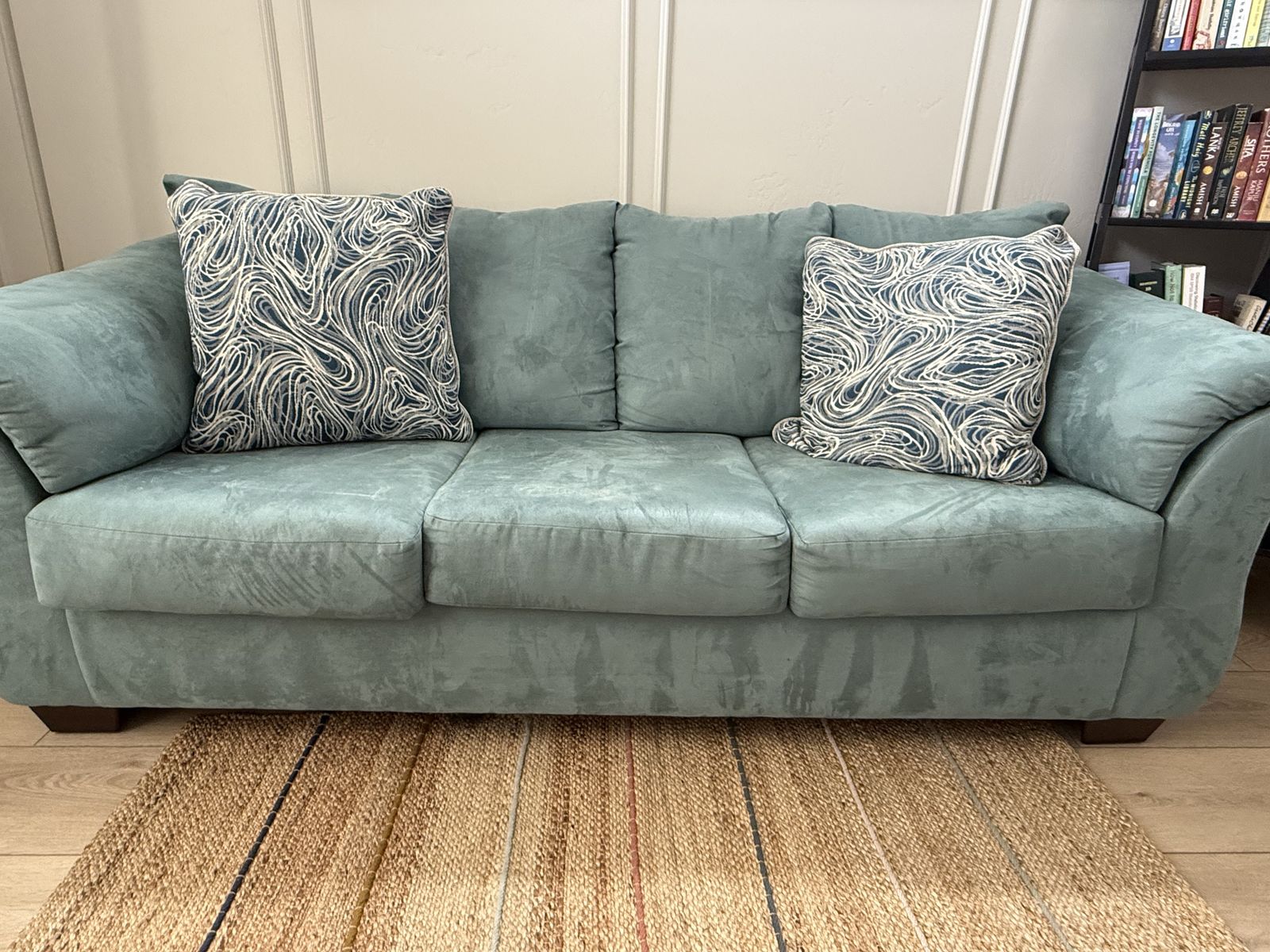Teal couch with pillows