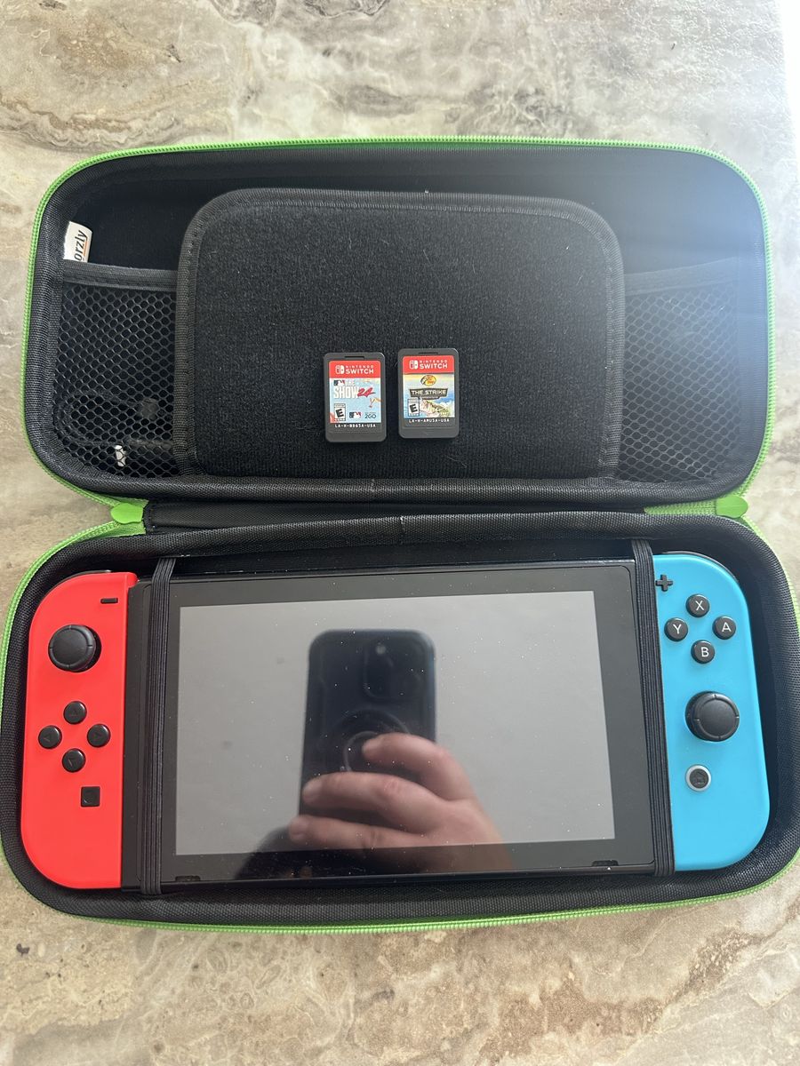 Nintendo Switch with dock and travel case and all the accessories and original charger. Included are 2 games