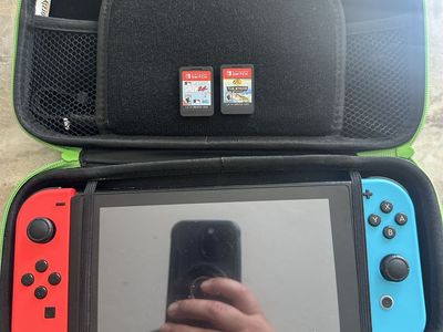 Nintendo Switch with dock and travel case and all the accessories and original charger. Included are 2 games