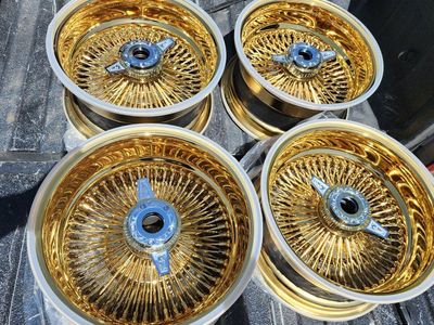 Set of Gold Wire Wheels with engraved knockoffs and Locking adapters brand new 14s