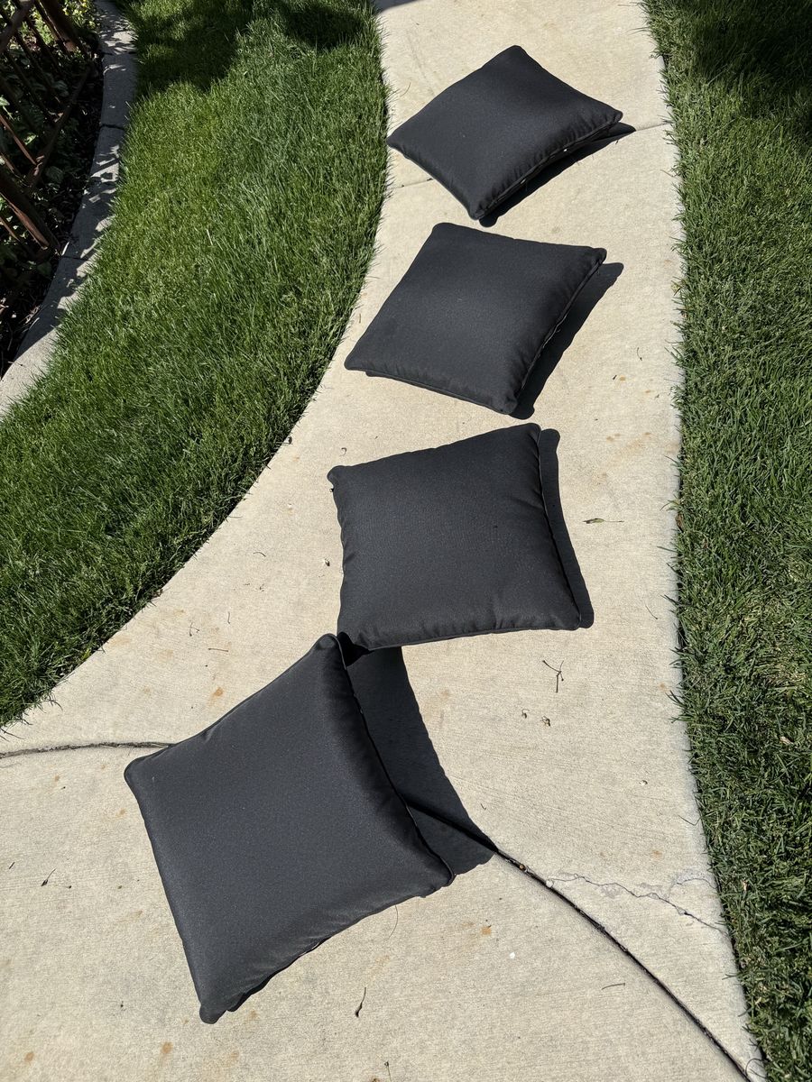 Set of 4 dark black toss pillows been in storage l