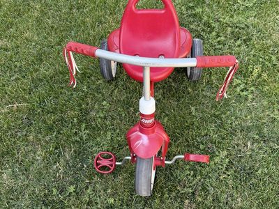 Radio Flyer Red Toddler Tricycle with Handlebar Streamers and Covered Storage Compartment