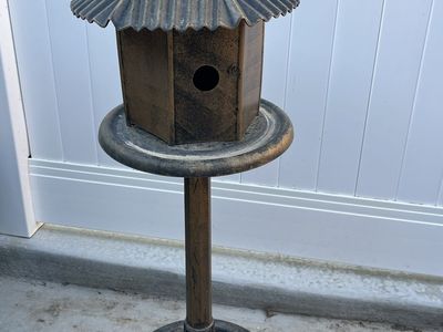 Cute birdhouse decoration that looks like cast iro