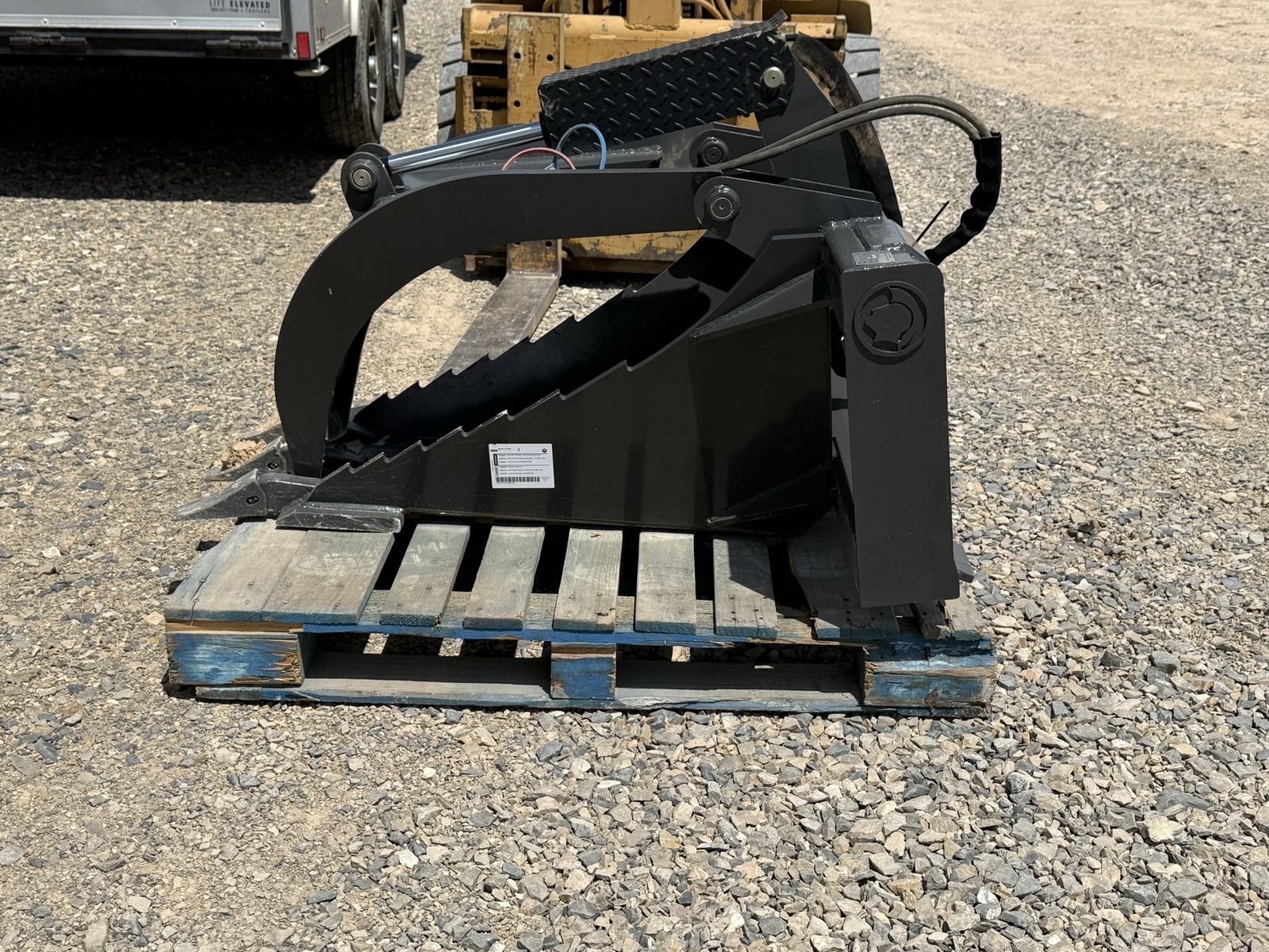 Root grapple for skid steer or track loader and machine that has a standard skid steer quick attach