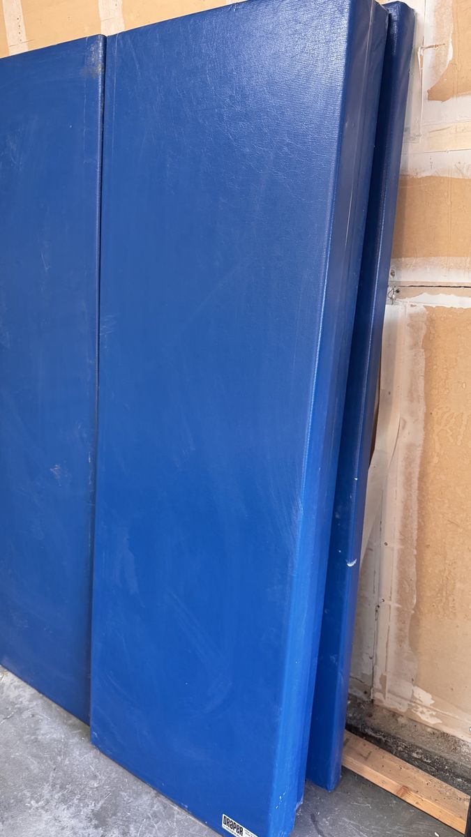 8 blue Draper brand vinyl-covered wall mats,