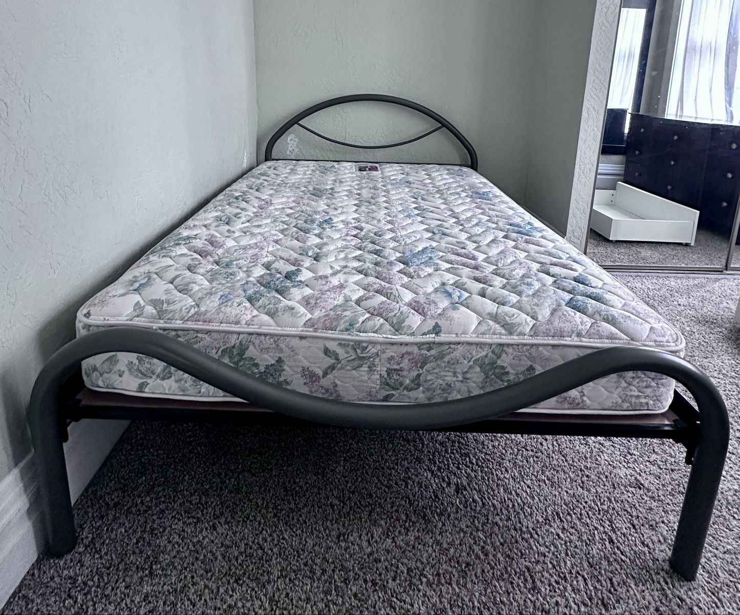 Queen bed tubular metal frame.