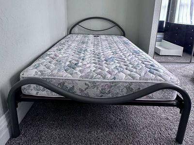 Queen bed tubular metal frame.