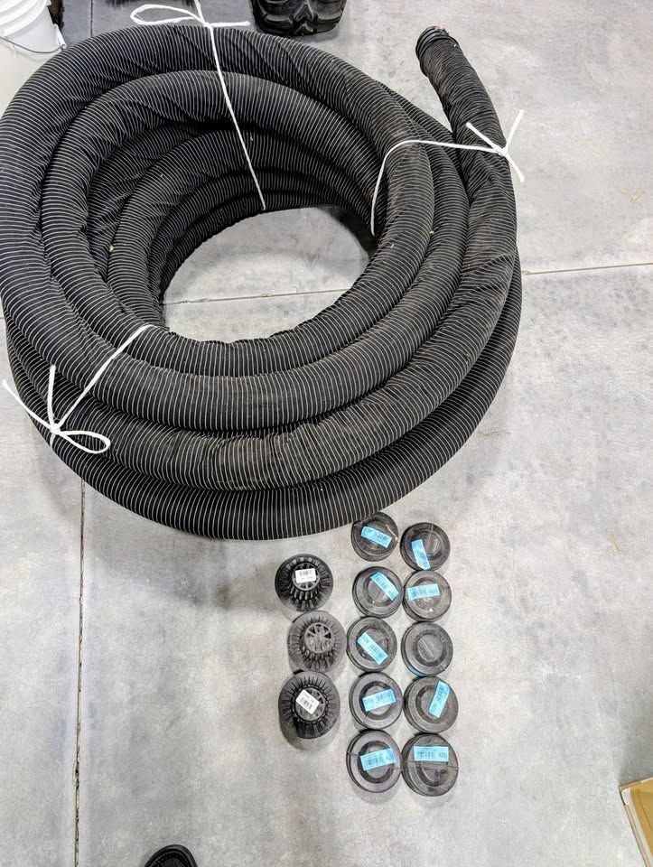 100' of 4" Perforated corrugated drainage pipe w/sleeve and caps/drainage spouts