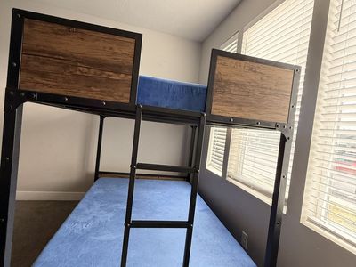 Metal bunk bed with wood panels