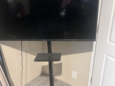 Vizio Smart TV Mounted on Rolling Mobile Stand with Shelf