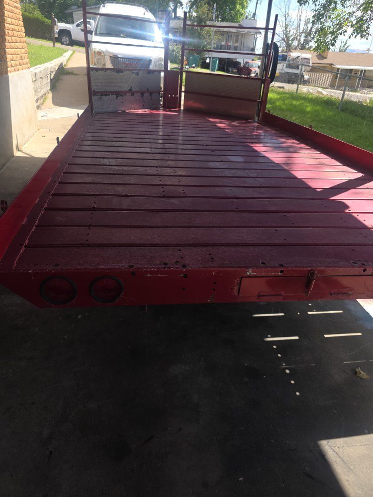 Red Dual Axle Utility Trailer with Metal Deck and High Rails