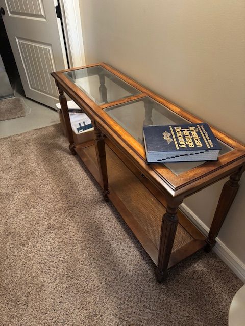 traditional glass-top console / sofa table with a lower shelf.