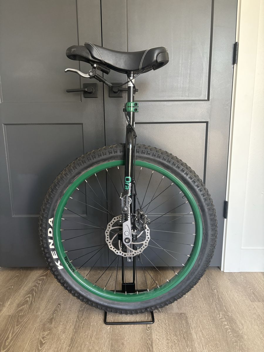 Nimbus Oracle Mountain Unicycle with safety gear.