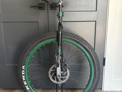 Nimbus Oracle Mountain Unicycle with safety gear.