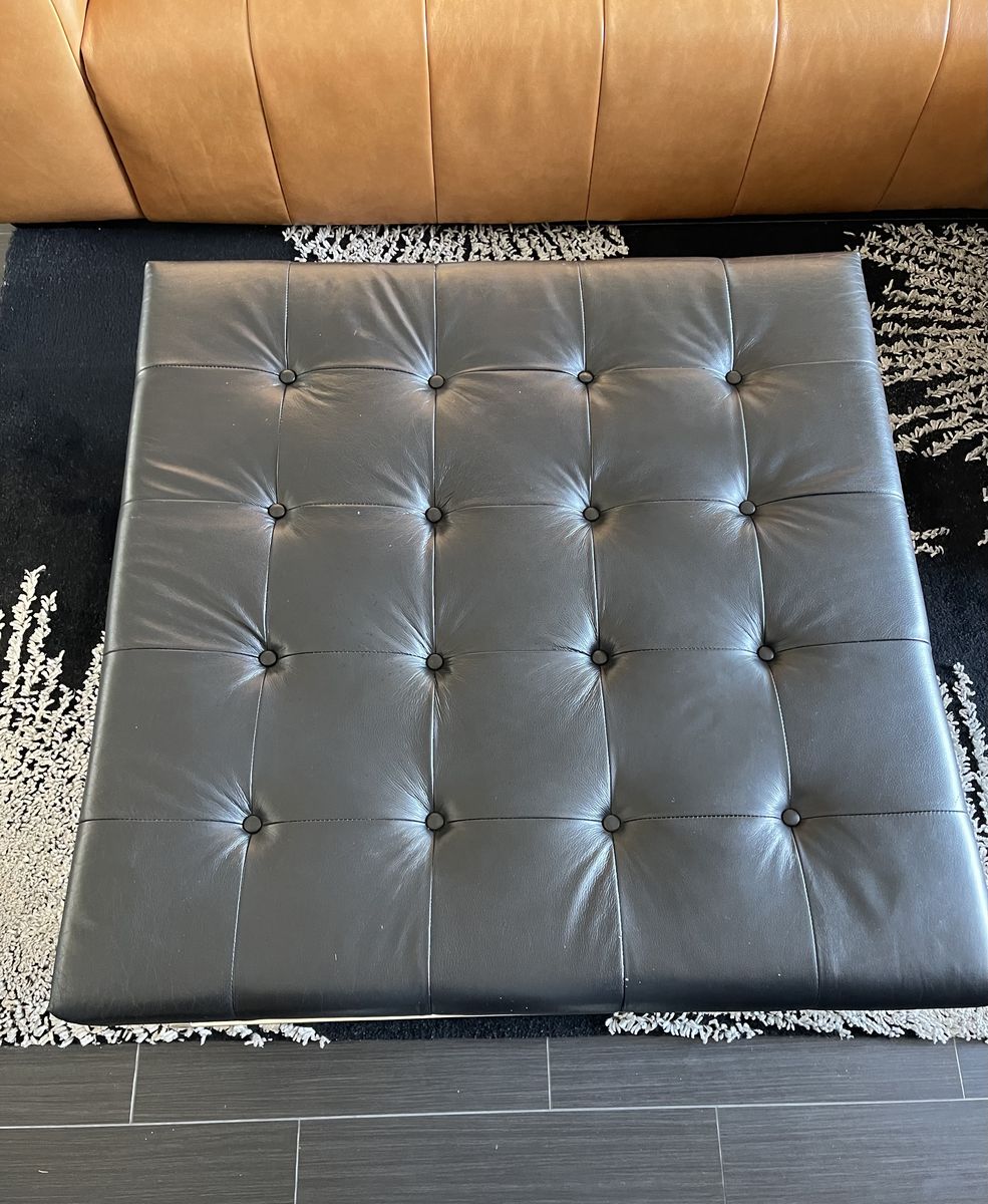 Black leather tufted ottoman