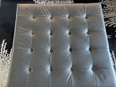 Black leather tufted ottoman