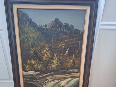 A mountain landscape with a waterfall and cacti oil painting with frame. 31.5" wide x 43.5" tall.