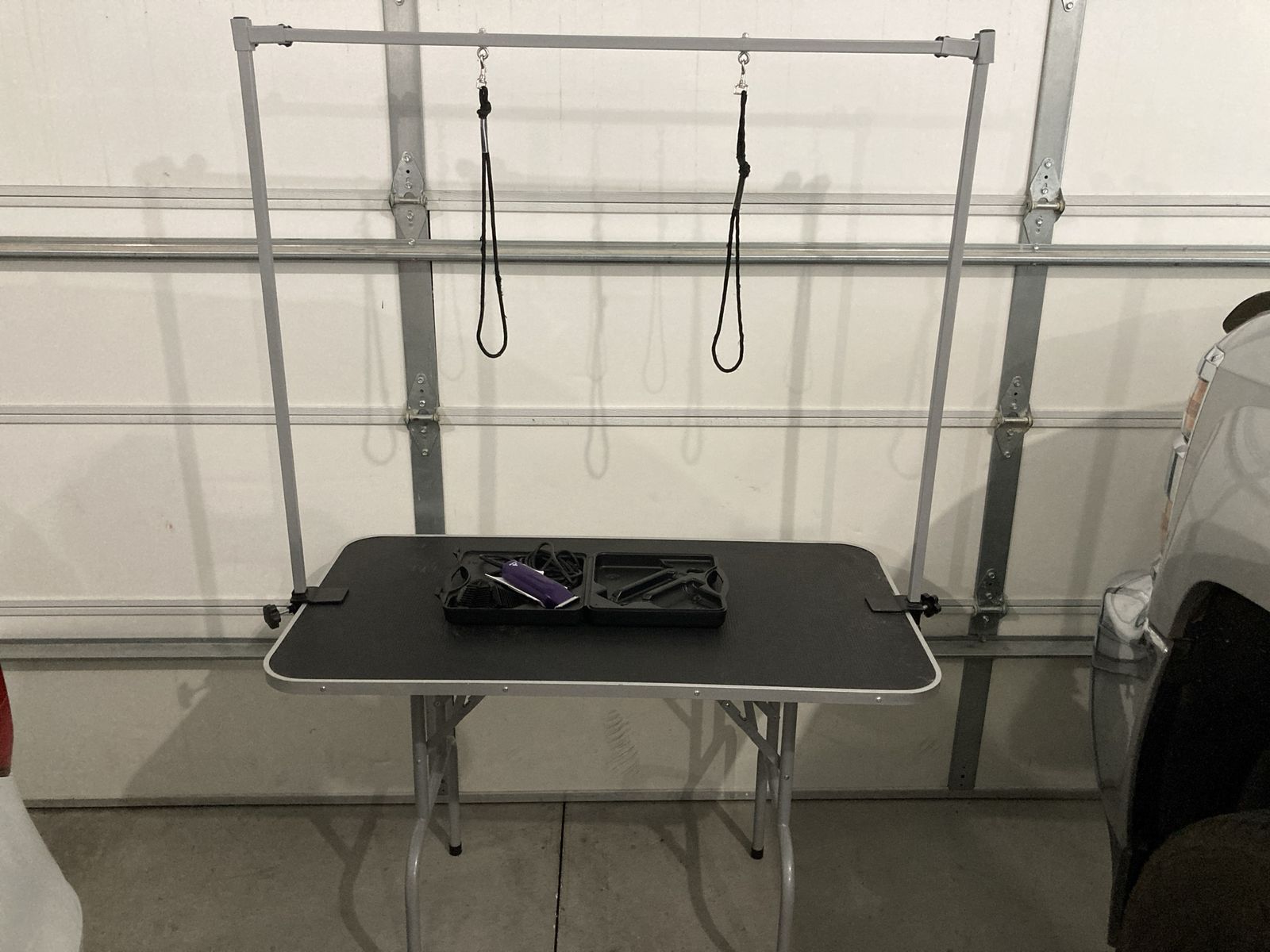 Dog grooming table and grooming clippers
