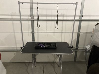Dog grooming table and grooming clippers