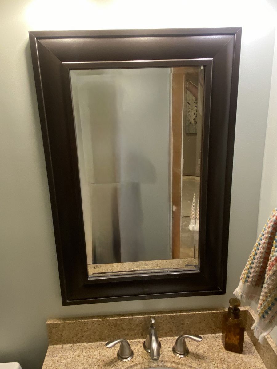 Bathroom, vanity, countertop, faucet, sink, and mirror