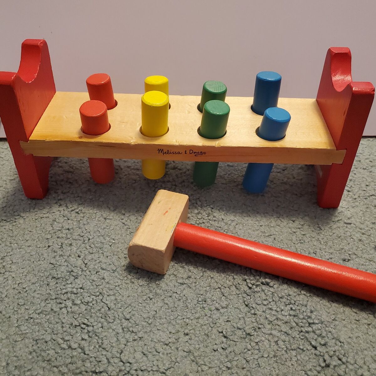 Melissa and Doug pound a peg
