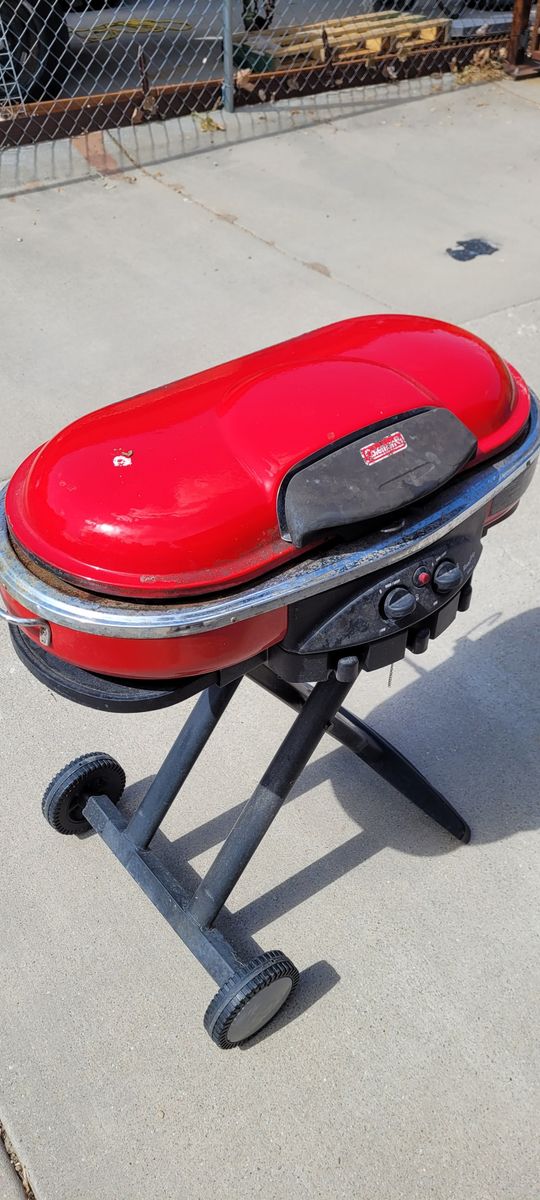 Coleman RoadTrip NXT 200 Red Propane Grill with Wheels - Portable & Ready for Adventure!
