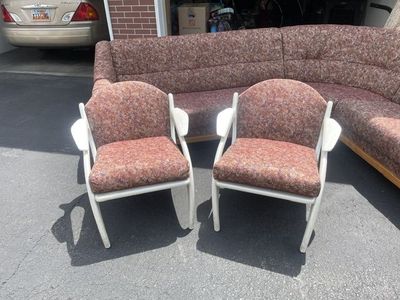 Sectional couch, two chairs and an area rug.