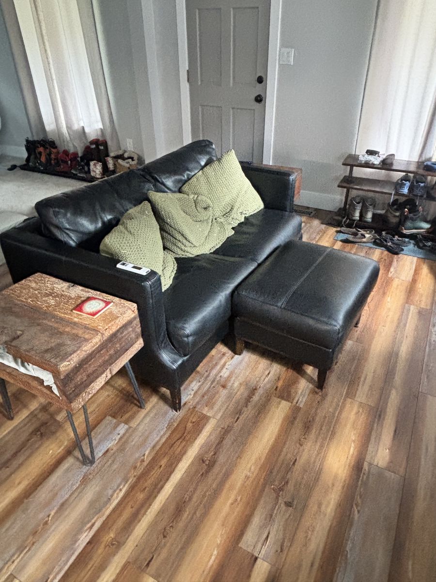 Black leather couch with pillows