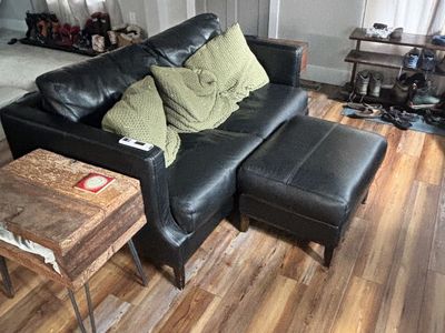 Black leather couch with pillows
