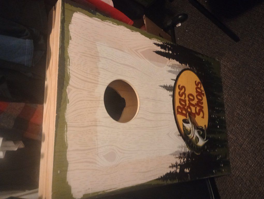 branmew corn hole game .and headphones.