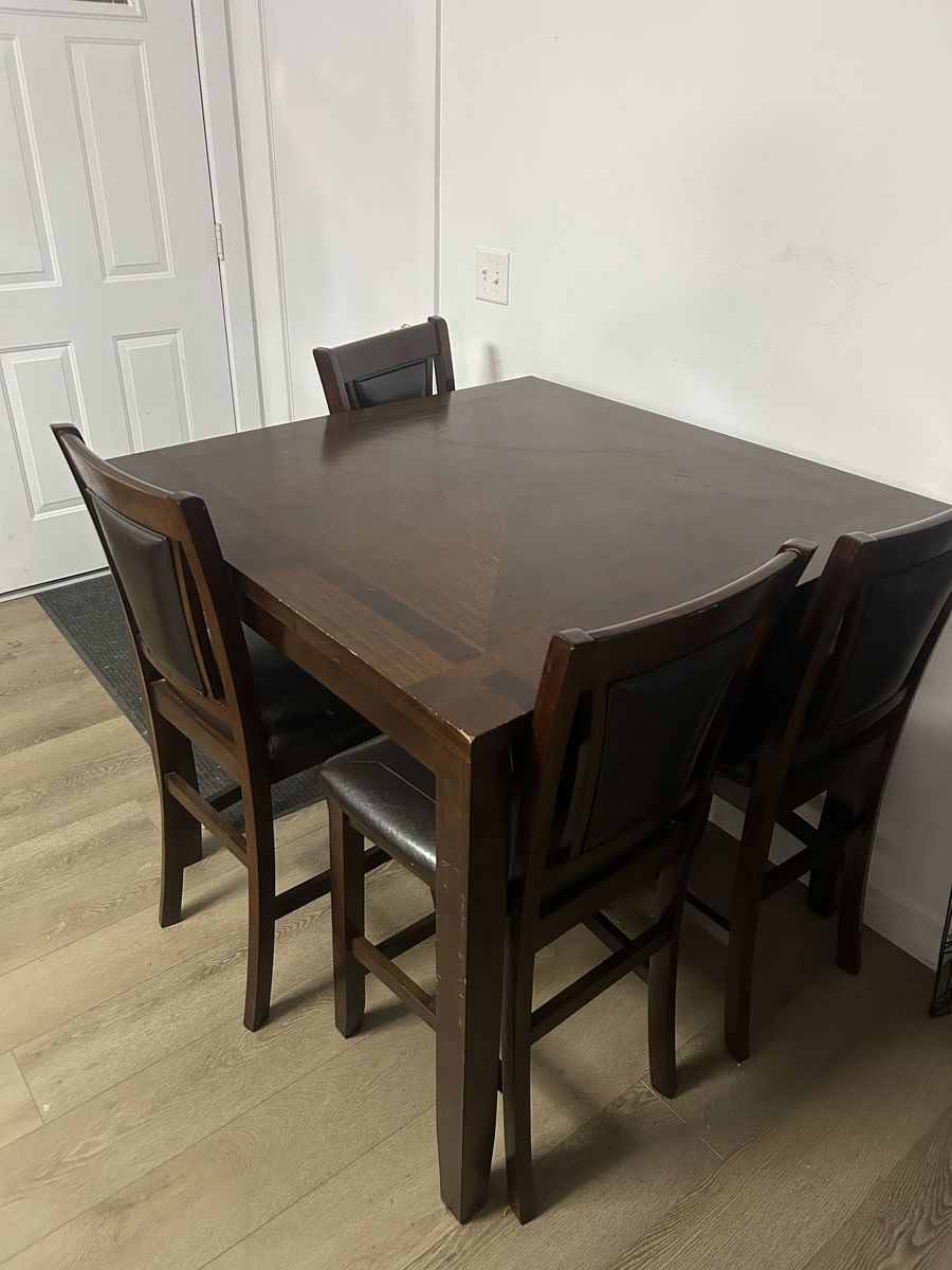 Brown wooden dining table with 4 chairs (42in wide, 42in long and 36in high)